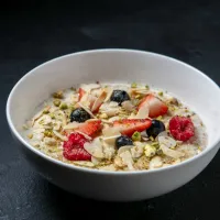 Oatmeal porridge with berries, banana and nuts